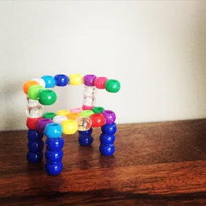 A miniature chair built from colorful beads