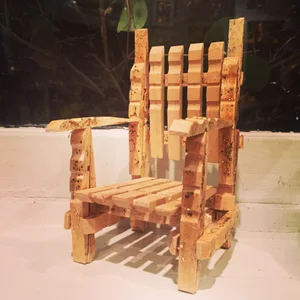 A miniature armchair made from narrow cork-like strips